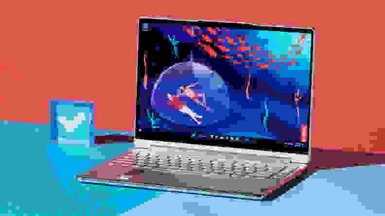 The laptop sits on a blue table.