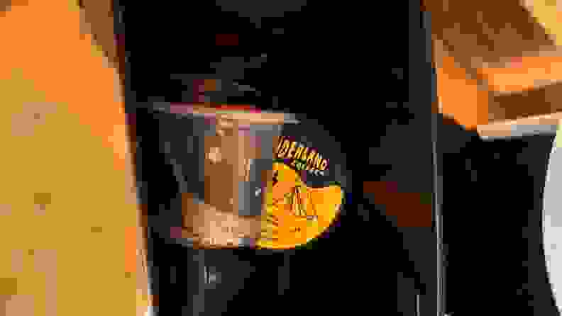 A few Bruvi coffee pods being held within the waste bin.