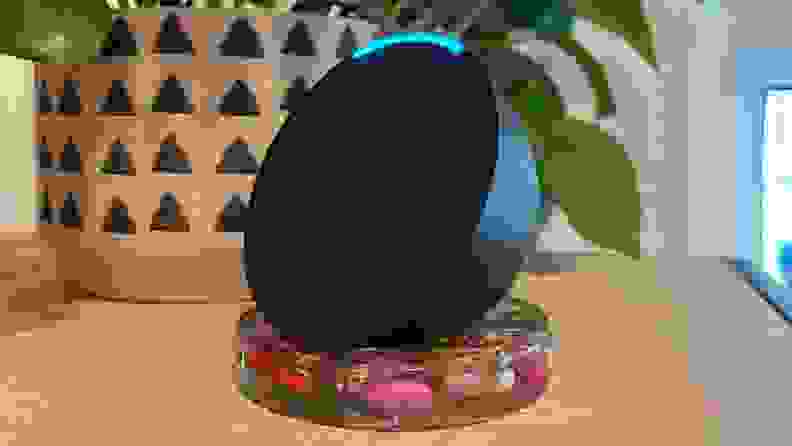 The Amazon Echo Pop sitting on a coaster.