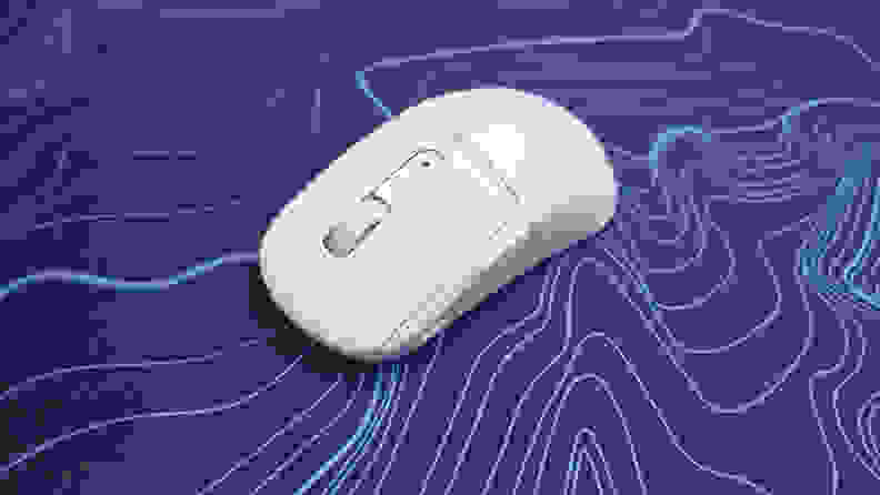 Close up angled view of the Turtle Beach Burst II Air mouse on top of a purple and blue patterned mousepad.
