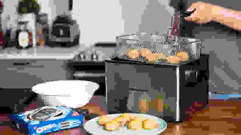 The Hamilton Beach Professional Grade Deep Fryer filled with fried food sits on a kitchen counter.