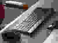 A picture of a wireless keyboard and mouse on a desk mat