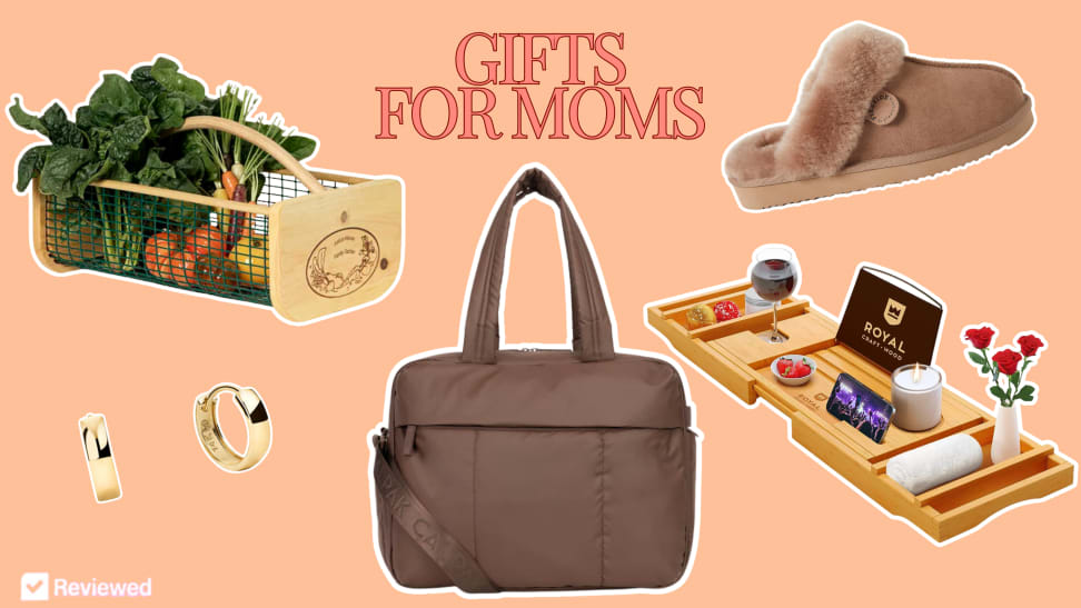 Mejuri hoop earrings, a Calpak Luke duffel, Dearfoam slippers, and a bath tray arranged together on a peach background.