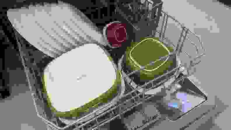 A close-up of the bottom rack of the Bosch dishwasher, filled with plates, ceramic cookware, and utensils.