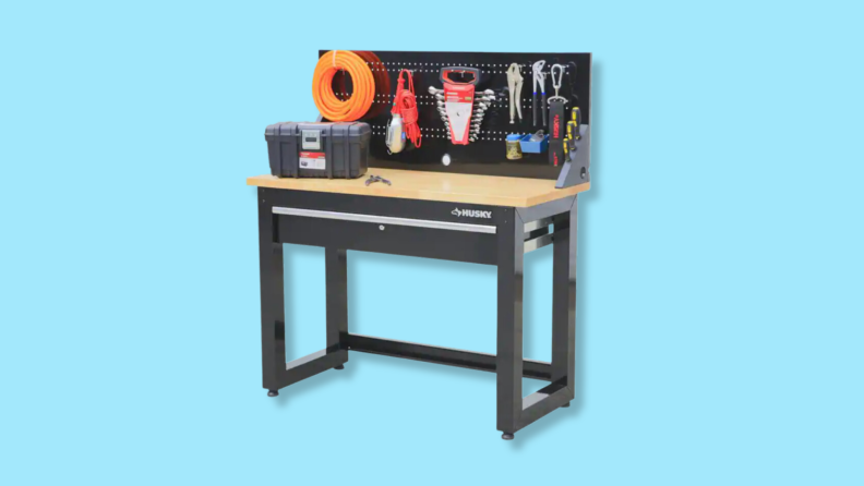 A metal work bench against a blue background.