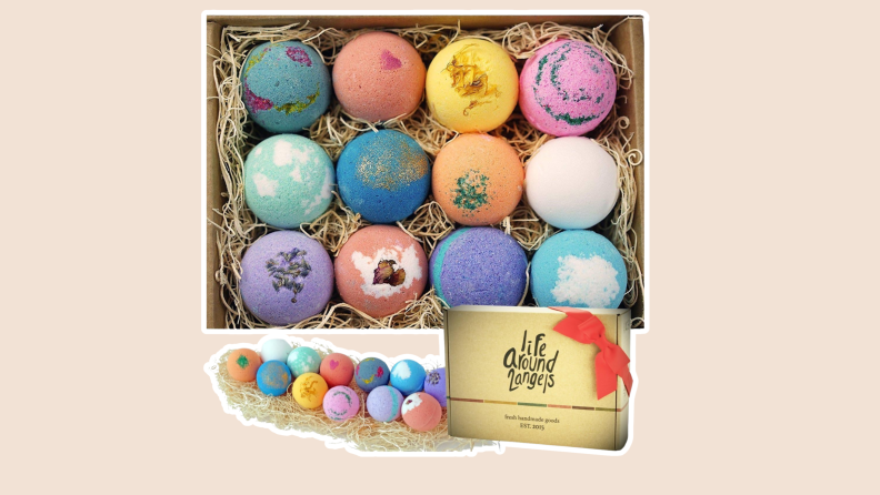 Colorful set of 12 LifeAround2Angels bath bombs inside of box on top of decorative straw.