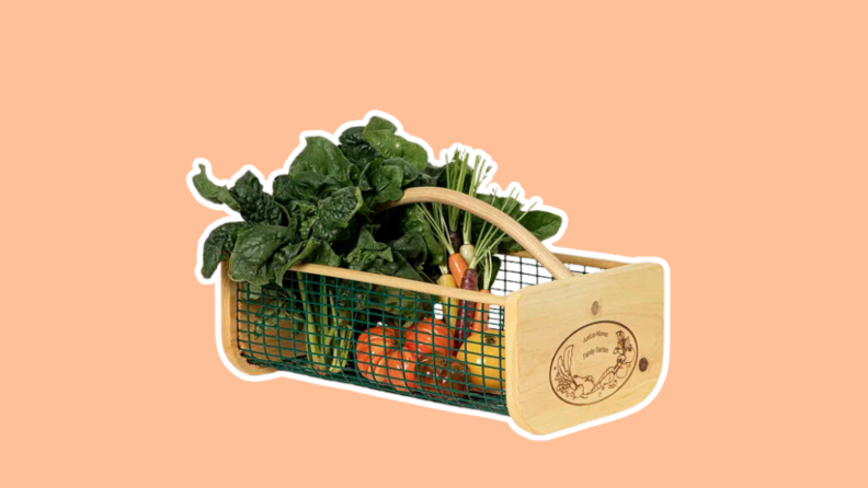 Assorted vegetables arranged in the Gardener's Harvest Basket, made of wood and wire.