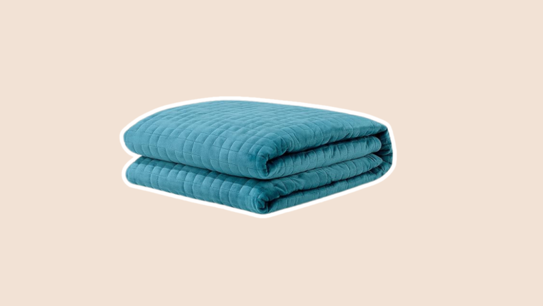 The Gravity Weighted Blanket in teal folded into square.