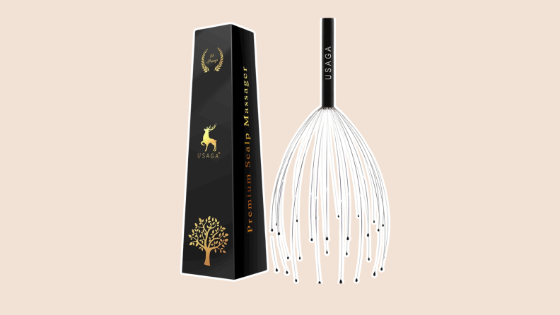 A finger head scratcher by the USAGA feature stainless steel massagers with rubber beads and the box it comes in.