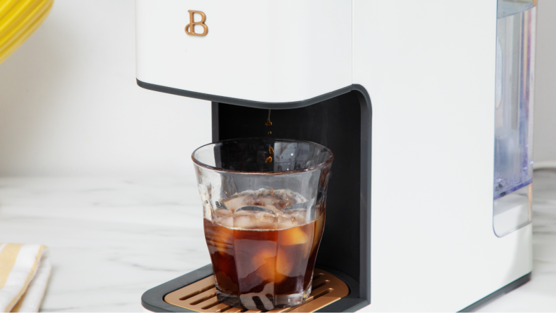 Close-up of a cup of iced coffee inside the coffee maker.
