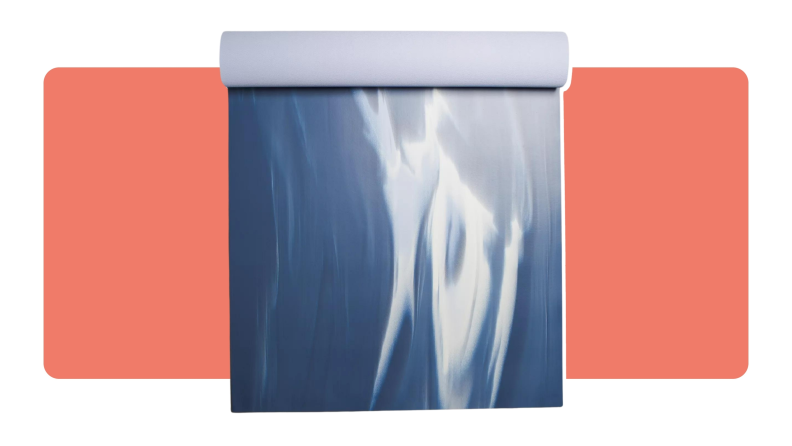 A blue and white lululemon yoga mat with an abstract print partially rolled up.