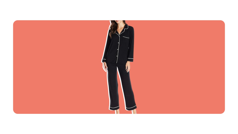 A model poses while wearing a black pair of Eberjey's Gisele Pajama Set.