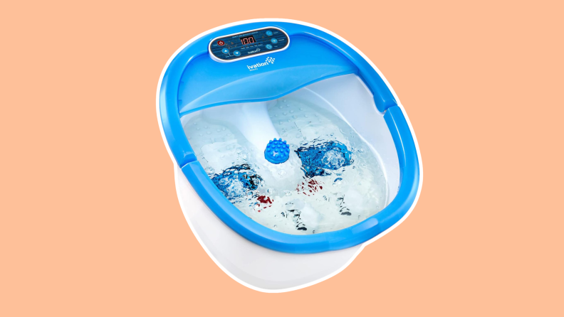A blue and white Ivation Foot Spa filled with water and bubbles.