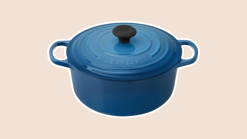 Product shot of the Le Creuset Dutch oven with lid attached in Marseille blue color.