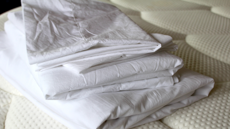 The best bed sheets made of percale fabric, the Sferra Giza sheets appear on a mattress in white.