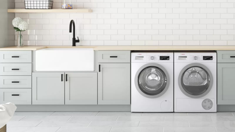 Matching washer and dryer in modern laundry room.