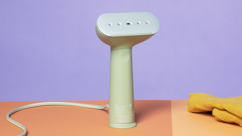The Steamery Cirrus 3 standing on a table with a purple background.