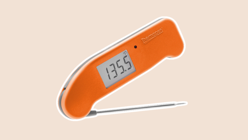 Product shot of the Thermapen One in orange color with temperature displayed on small screen.